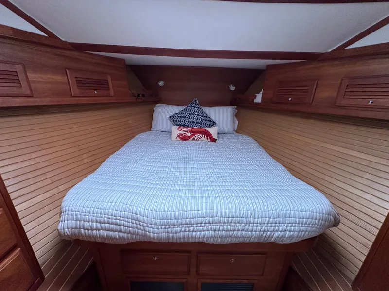 Slide: The Image of Cozy cabin bedroom in 2006 Sabre 42 Hard Top Express yacht with wood paneling. - 10