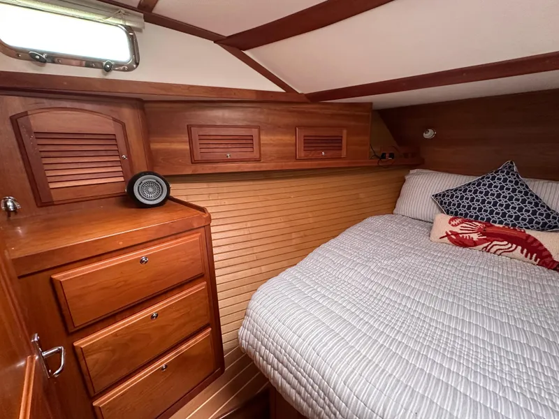Slide: The Image of 2006 Sabre 42 Hard Top Express cabin with wooden cabinetry and cozy bed. - 11