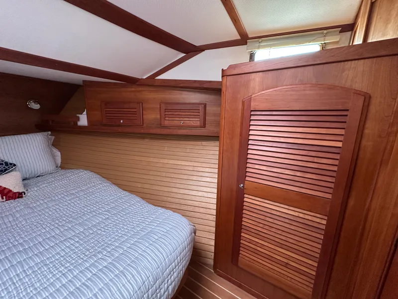 Slide: The Image of 2006 Sabre 42 Hard Top Express cabin with wooden interior and cozy bed. - 12