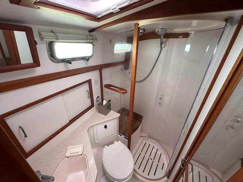 Slide: The Image of 2006 Sabre 42 Hard Top Express yacht bathroom with shower, toilet, and wooden accents. - 13