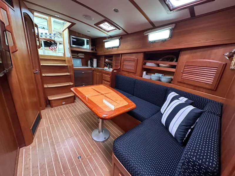 Slide: The Image of 2006 Sabre 42 Hard Top Express interior with wooden finish, dining area, and stairs to cockpit. - 16