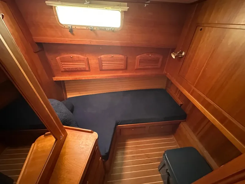 Slide: The Image of 2006 Sabre 42 Hard Top Express cabin with wooden interior and blue cushions. - 17