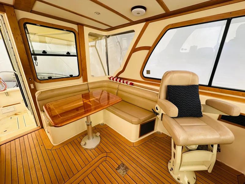 Slide: The Image of 2006 Sabre 42 Hard Top Express interior with leather seating and wooden table. - 4