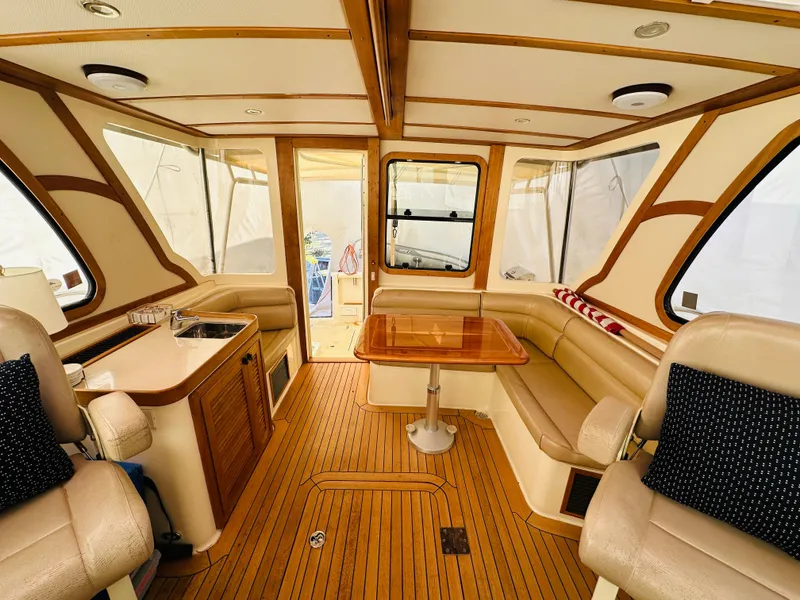 Slide: The Image of 2006 Sabre 42 Hard Top Express interior with wood accents and beige seating. - 5