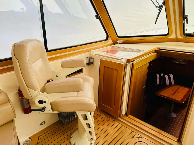 Slide: The Image of Interior of 2006 Sabre 42 Hard Top Express, featuring helm seat and cabin entrance. - 6