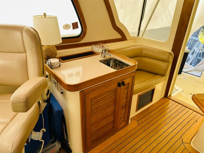 Slide: The Image of Interior of 2006 Sabre 42 Hard Top Express with sink, seating, and wooden cabinetry. - 7