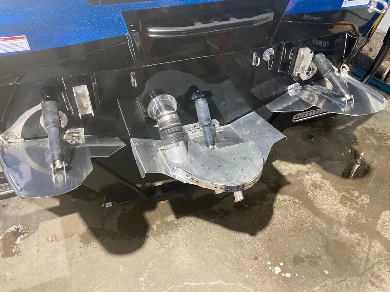 Slide: The Image of 2023 Centurion Ri230 boat propellers and rudder system on a wet surface. - 6