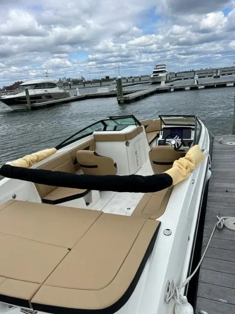 Slide: The Image of 2023 Sea Ray SPX 230 OB boat docked at marina, featuring spacious seating and sleek design. - 3