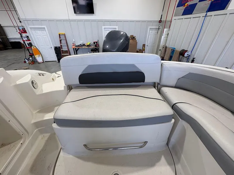 Slide: The Image of 2017 SouthWind 2400 SD boat interior with gray and white seating in a garage setting. - 12