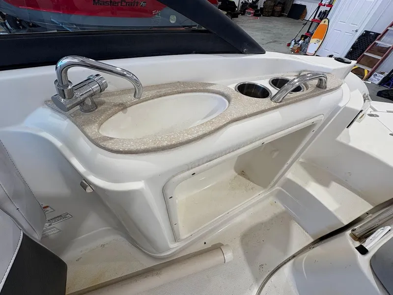 Slide: The Image of 2017 SouthWind 2400 SD boat sink and countertop with storage compartment. - 13