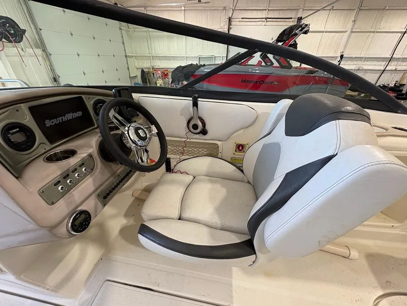 Slide: The Image of 2017 SouthWind 2400 SD boat interior with steering wheel and seating. - 14