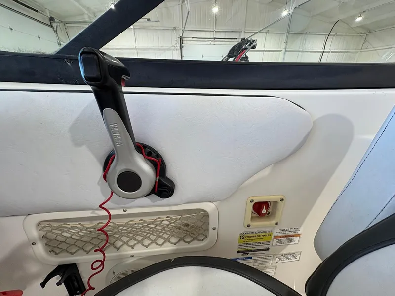 Slide: The Image of Interior view of a 2017 SouthWind 2400 SD boat, featuring throttle control and safety instructions. - 16