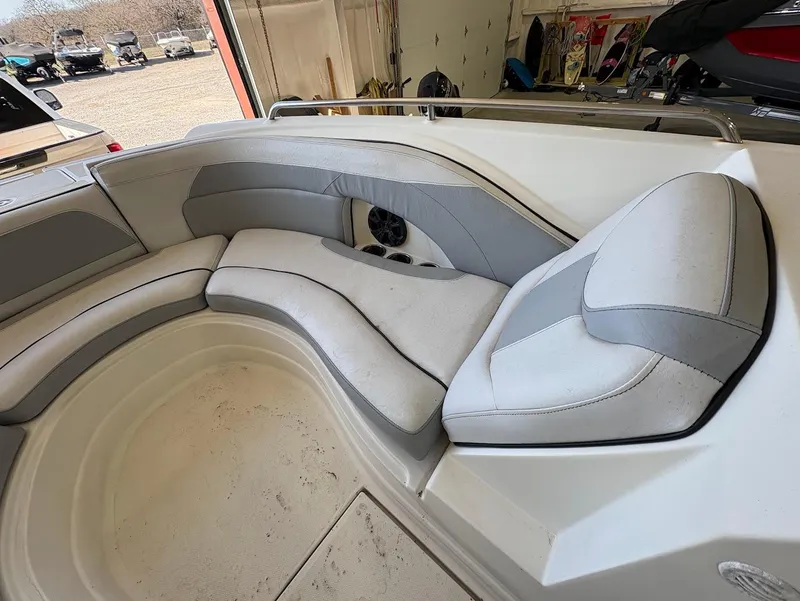 Slide: The Image of 2017 SouthWind 2400 SD boat interior with cushioned seating in a garage setting. - 17