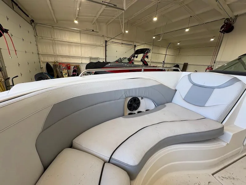 Slide: The Image of 2017 SouthWind 2400 SD boat interior with cushioned seating in a spacious garage. - 19