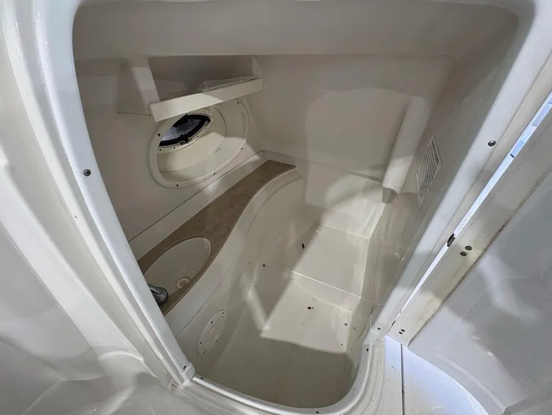Slide: The Image of 2017 SouthWind 2400 SD boat interior cabin with storage and seating area. - 21