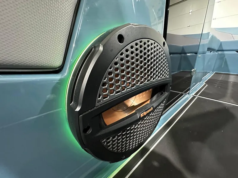 Slide: The Image of Speaker detail on 2025 MasterCraft NXT23 boat, featuring modern design and green LED lighting. - 17
