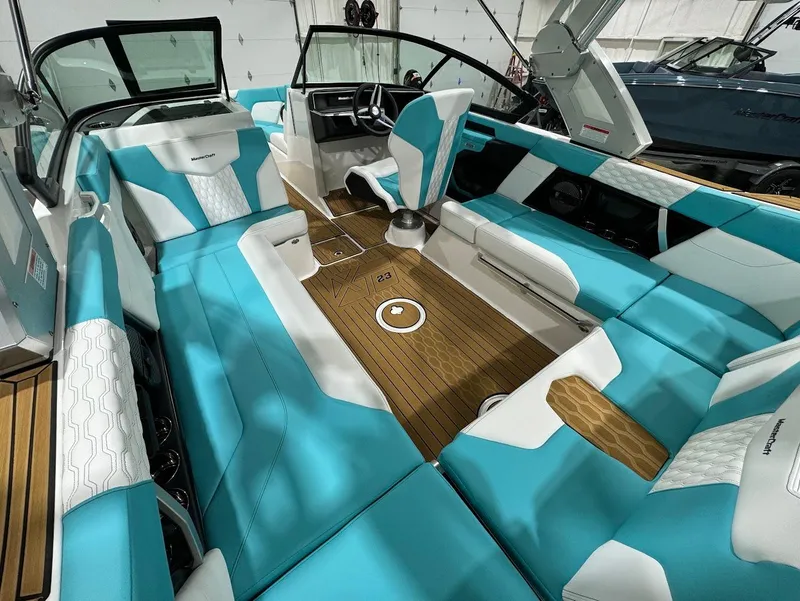 Slide: The Image of 2025 MasterCraft XT23 boat interior with turquoise and white seating, featuring a sleek, modern design. - 21