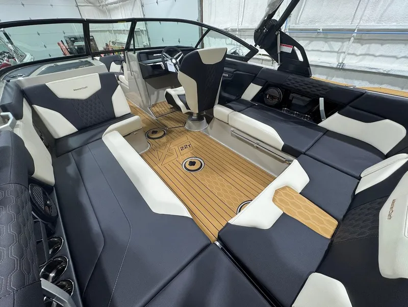 Slide: The Image of 2025 MasterCraft XT22 T boat interior with luxurious seating and modern design. - 10
