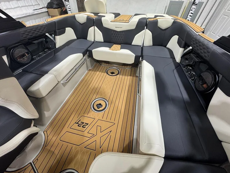 Slide: The Image of 2025 MasterCraft XT22 T boat interior with sleek seating and modern design. - 11
