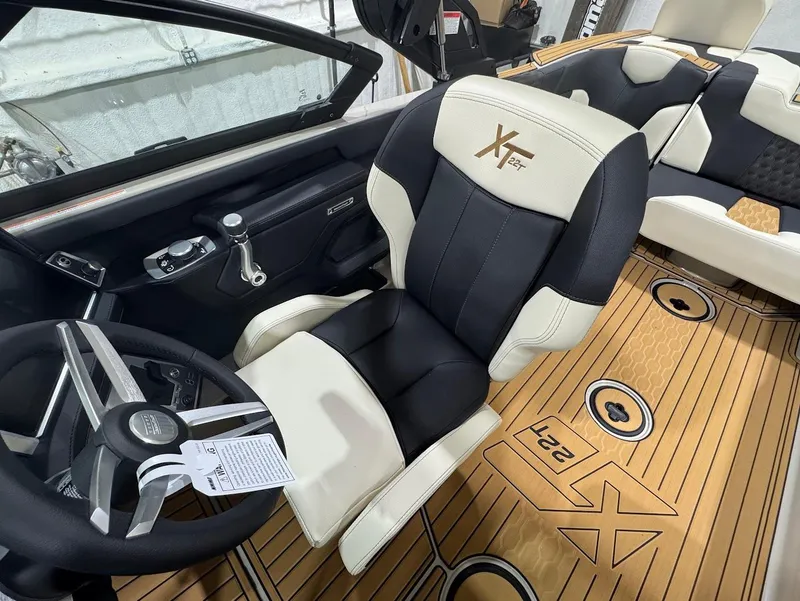 Slide: The Image of 2025 MasterCraft XT22 T boat interior with luxurious seating and modern design. - 12