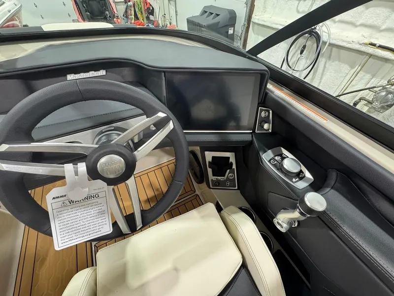 Slide: The Image of 2025 MasterCraft XT22 T boat interior with sleek seating and advanced audio system. - 13