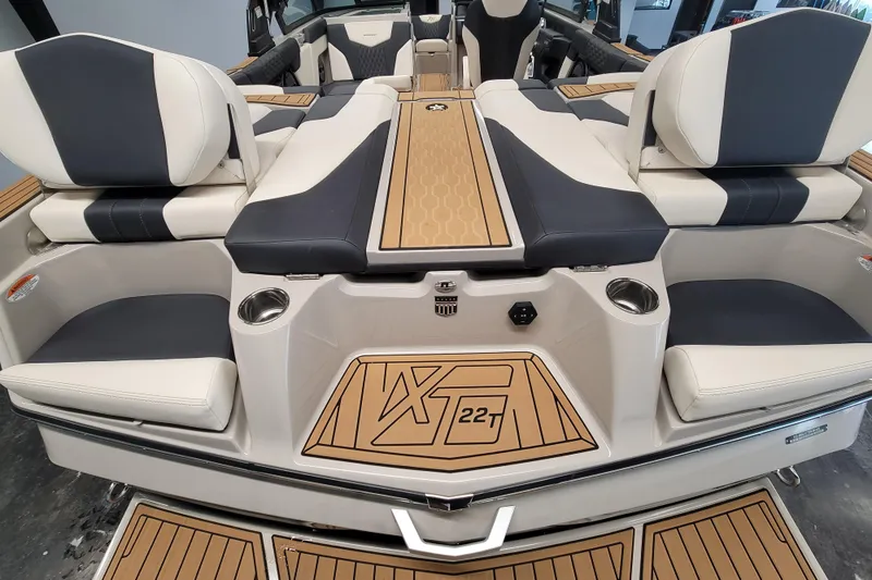 Slide: The Image of 2025 MasterCraft XT22 T boat interior with luxurious seating and modern design. - 22