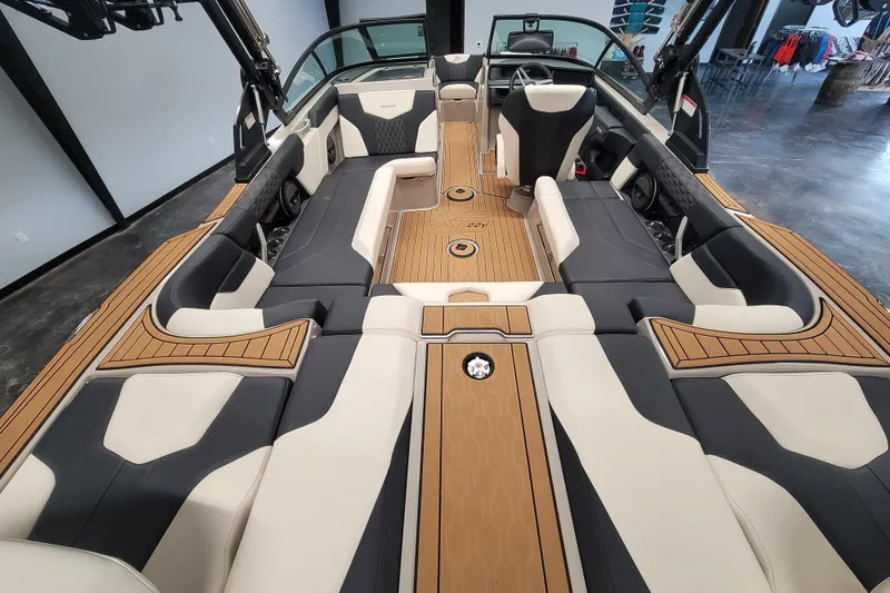 Slide: The Image of 2025 MasterCraft XT22 T boat interior with luxurious seating and modern design. - 24