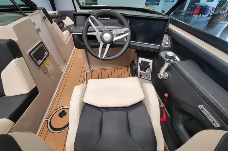 Slide: The Image of 2025 MasterCraft XT22 T boat interior with modern steering and control panel. - 26