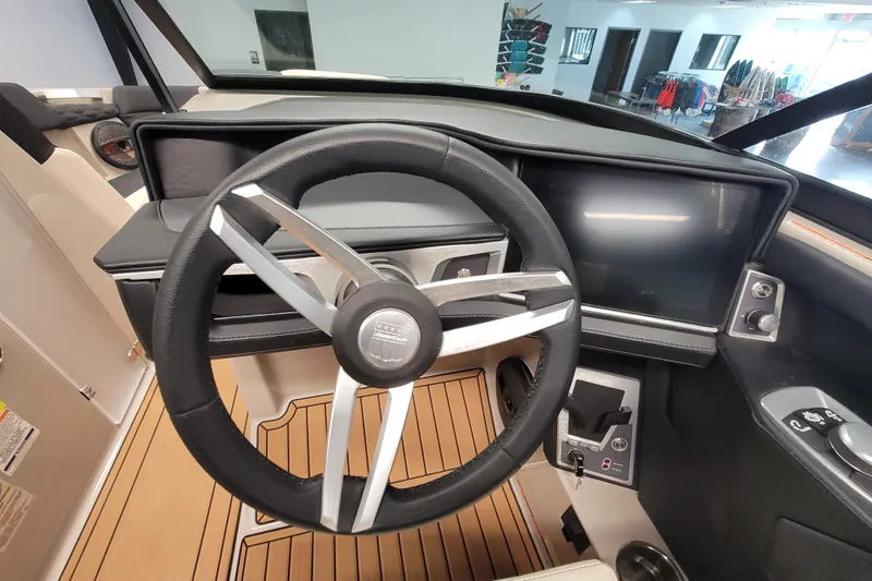 Slide: The Image of 2025 MasterCraft XT22 T boat dashboard with steering wheel and digital display. - 27