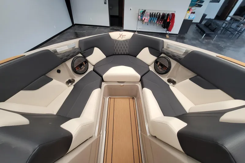 Slide: The Image of 2025 MasterCraft XT22 T boat interior with luxurious seating and modern design. - 28