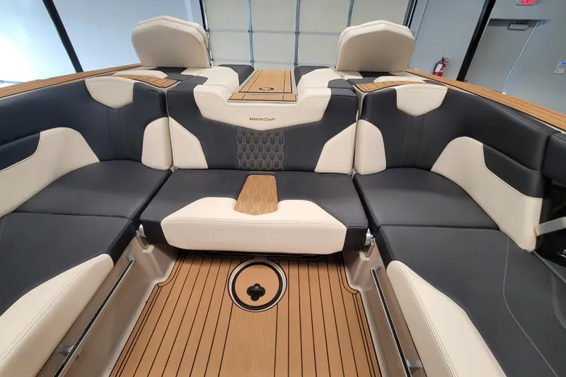 Slide: The Image of 2025 MasterCraft XT22 T boat interior with luxurious seating and teak flooring. - 30