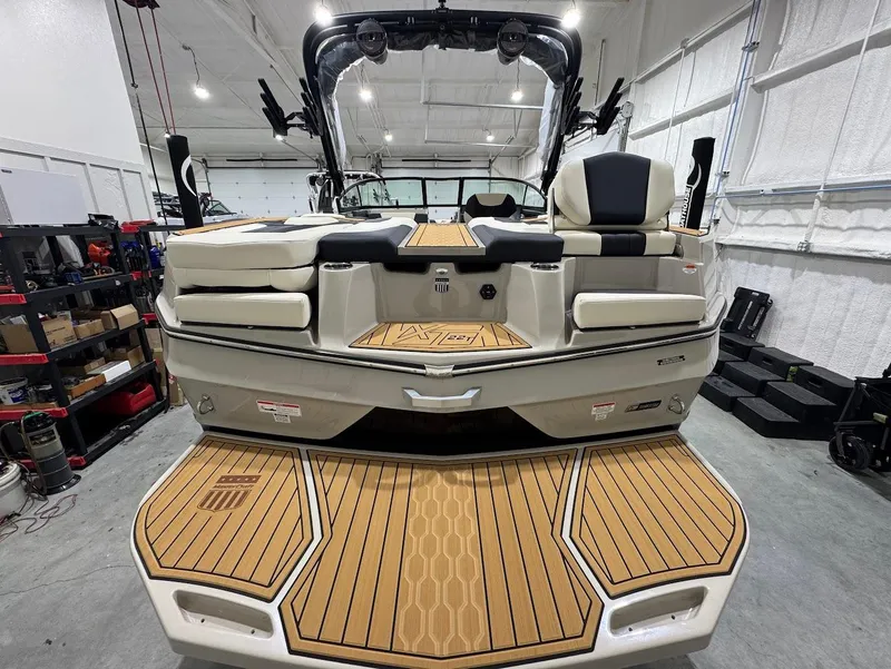 Slide: The Image of 2025 MasterCraft XT22 T boat on trailer in showroom, front view. - 4