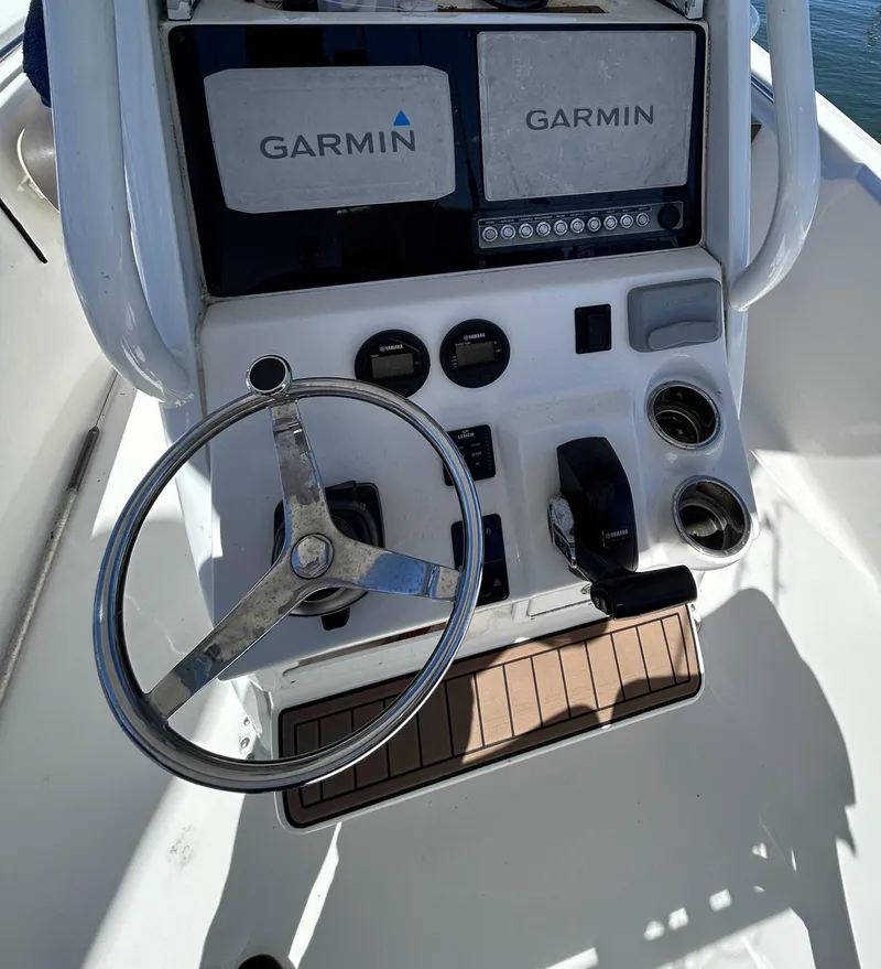 Slide: The Image of 2018 Tidewater 232 LXF boat console with Garmin navigation system and steering wheel. - 4