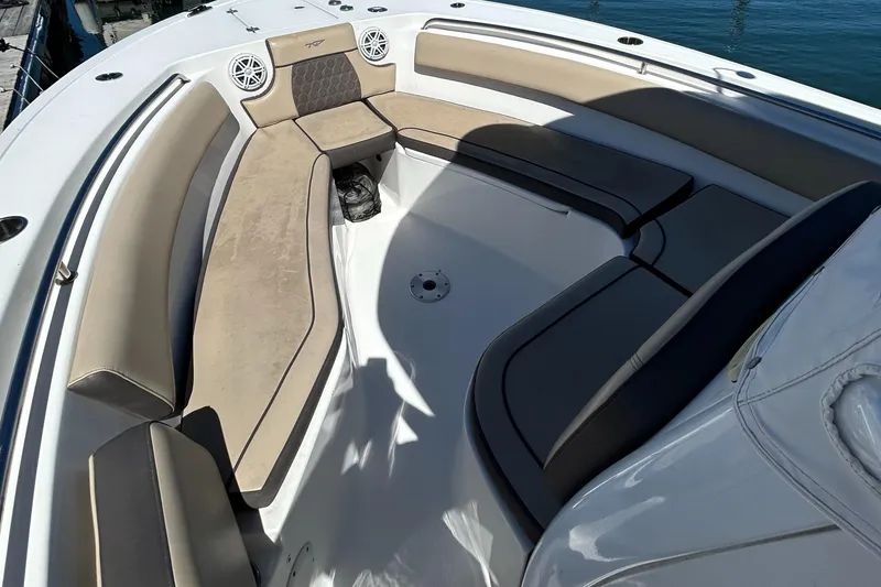 Slide: The Image of 2018 Tidewater 232 LXF boat interior with cushioned seating and speakers. - 5