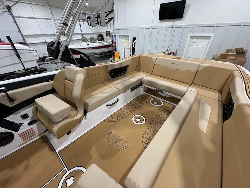 Slide: The Image of 2025 MasterCraft NXT24 boat interior with beige seating and modern design. - 11
