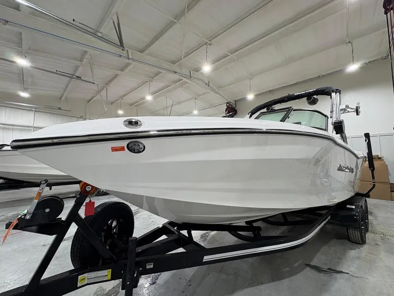 Slide: The Image of 2025 MasterCraft NXT24 boat in a showroom, showcasing sleek design and modern features. - 4