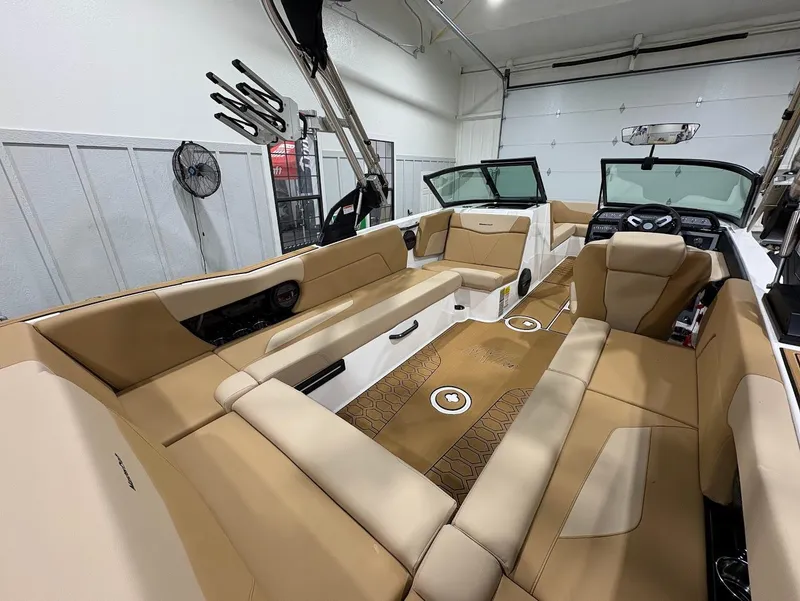 Slide: The Image of 2025 MasterCraft NXT24 boat interior with tan seating and modern design. - 9
