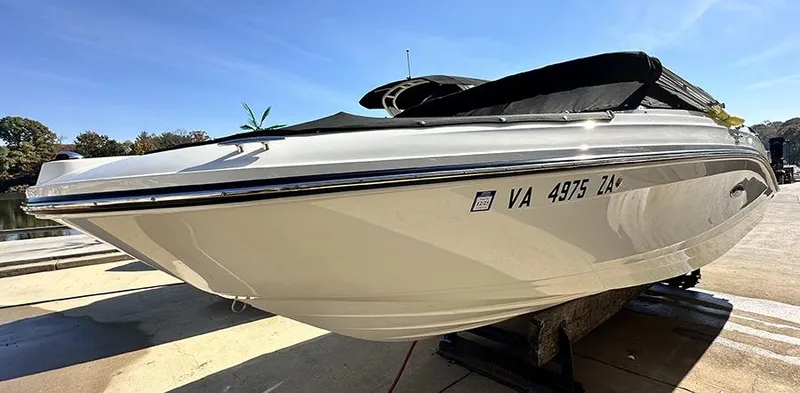Slide: The Image of 2019 Sea Ray SPX 230 OB boat on dock, side view, clear sky background. - 4