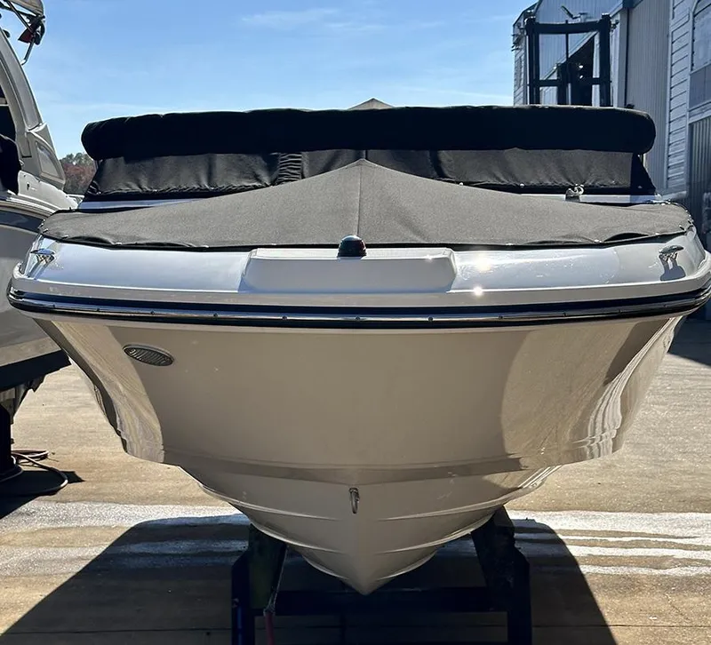 Slide: The Image of 2019 Sea Ray SPX 230 OB boat with black cover, docked outdoors. - 5