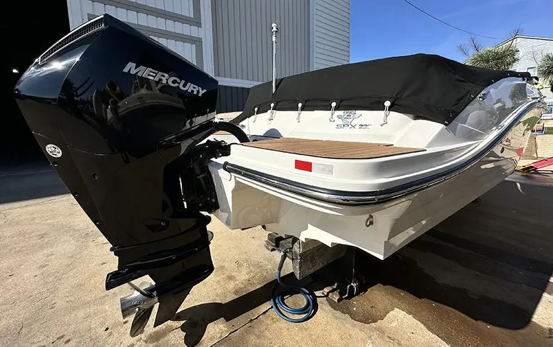 Slide: The Image of 2019 Sea Ray SPX 230 OB boat with Mercury outboard engine, docked outdoors. - 7