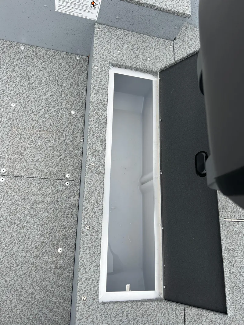 Slide: The Image of 2025 Lund 1600 Fury Tiller boat interior with open storage compartment. - 13