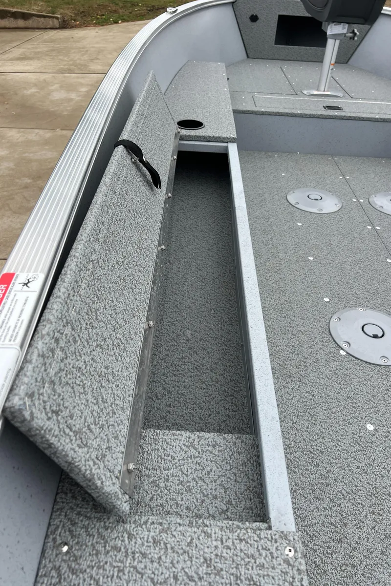 Slide: The Image of 2025 Lund 1600 Fury Tiller boat interior with storage compartment and seating. - 15