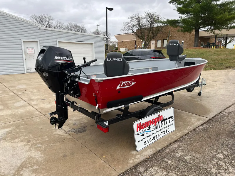 Slide: The Image of 2025 Lund 1600 Fury Tiller boat with Mercury engine, displayed outdoors. - 7