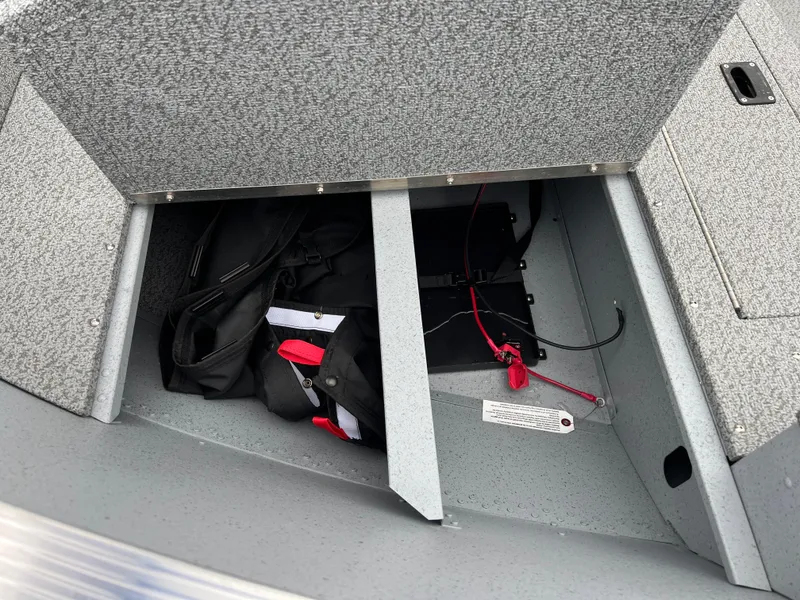 Slide: The Image of Storage compartment of 2025 Lund 1600 Fury Tiller boat with gear and cables. - 9