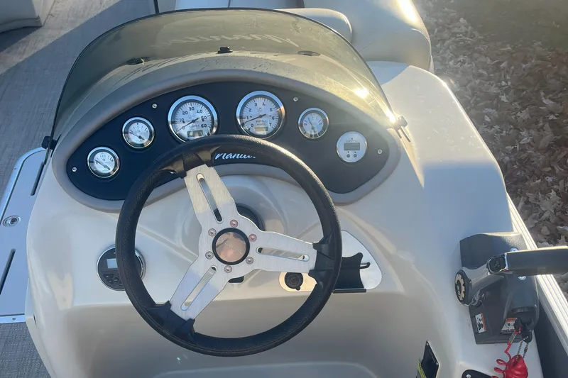 Slide: The Image of Steering console of a 2015 Manitou 25 Oasis SR boat with gauges and controls. - 7