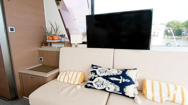 Slide: The Image of Modern yacht interior with beige sofa, decorative pillows, and a flat-screen TV. Bali 5.4, 2021 model. - 20