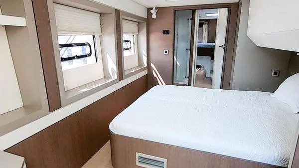 Slide: The Image of Modern bedroom interior on a 2021 Bali 5.4 yacht, featuring large windows and a comfortable bed. - 27