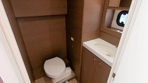Slide: The Image of Modern yacht bathroom with wooden cabinetry, toilet, and sink. Bali 5.4, 2021 model. - 28