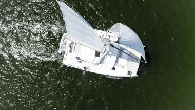 Slide: The Image of Aerial view of 2021 Bali 5.4 sailboat navigating through green waters. - 3