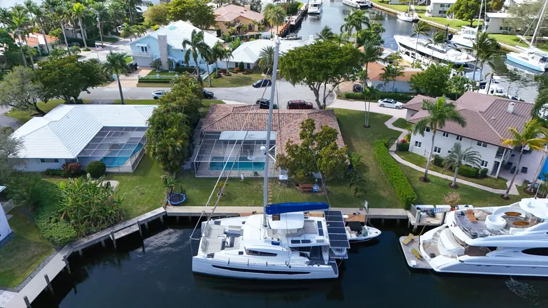 Slide: The Image of Aerial view of a 2021 Bali 5.4 catamaran docked in a residential canal. - 33